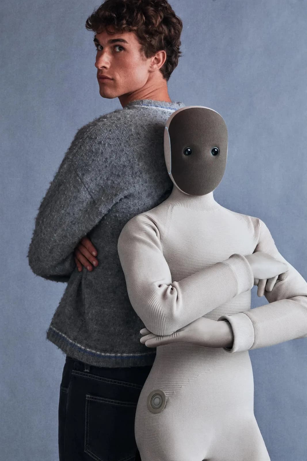 A woman stands beside the 1X NEO home robot
