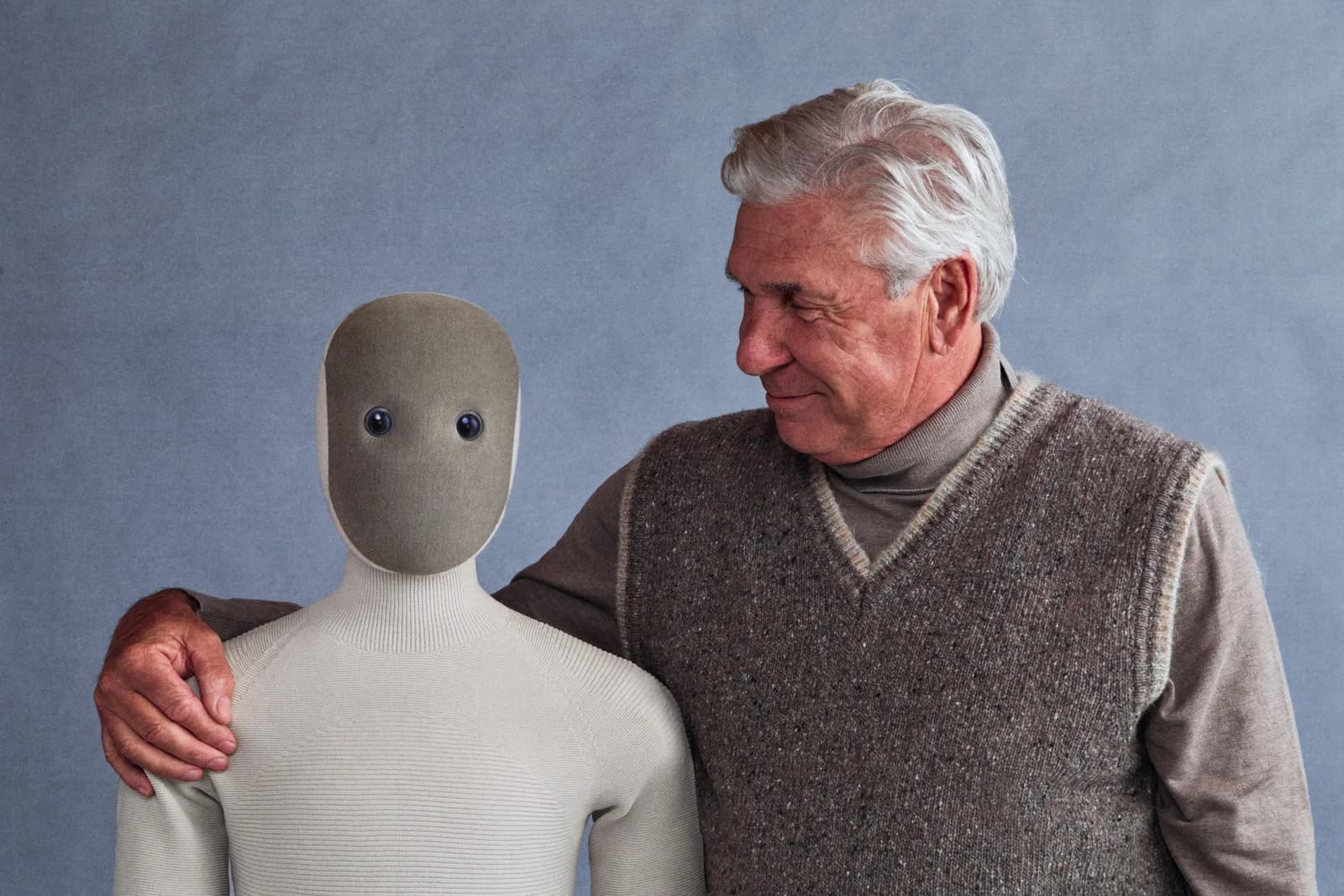 1X NEO robot with its hand on an older man's shoulder