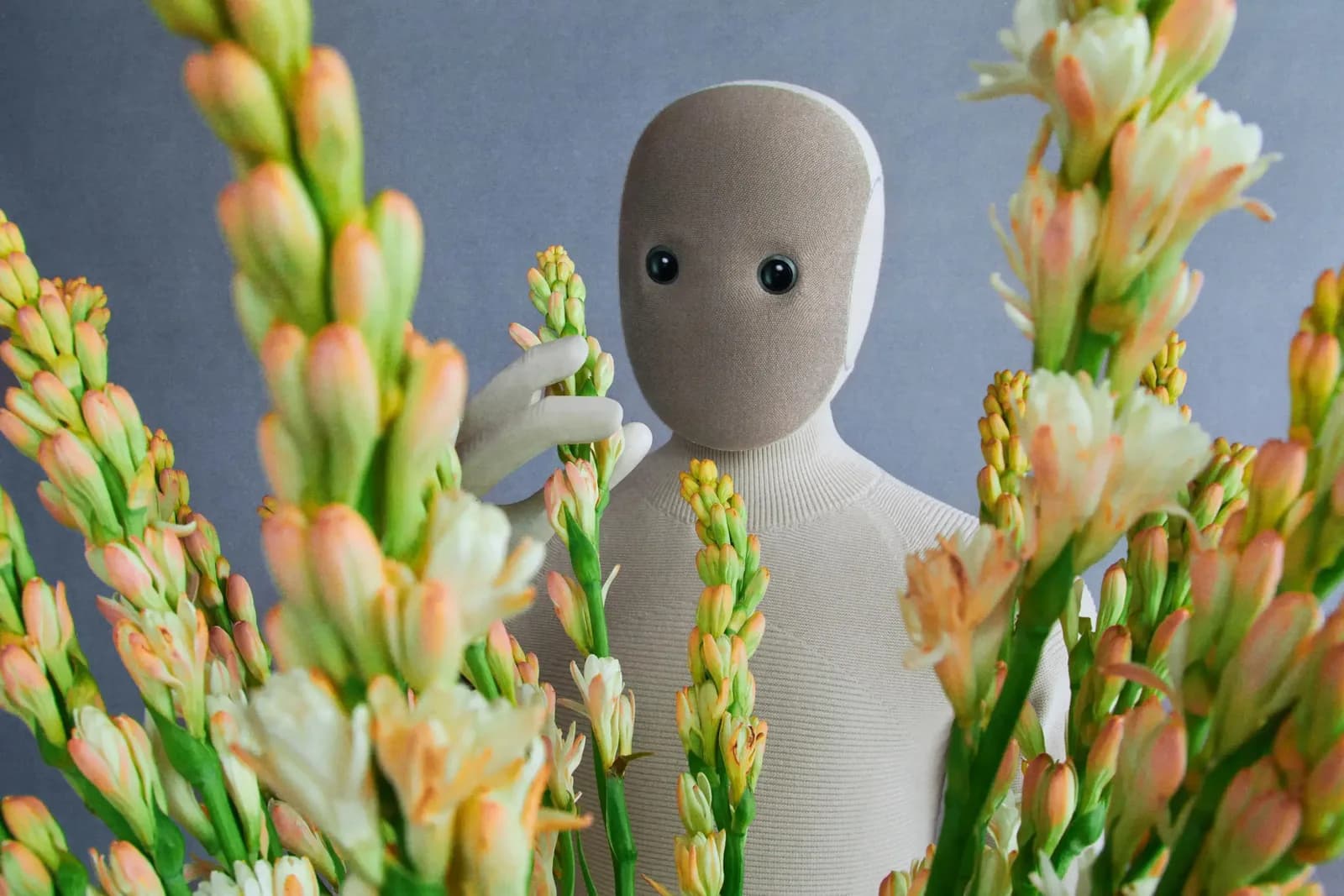 1X NEO robot holding a bunch of flowers