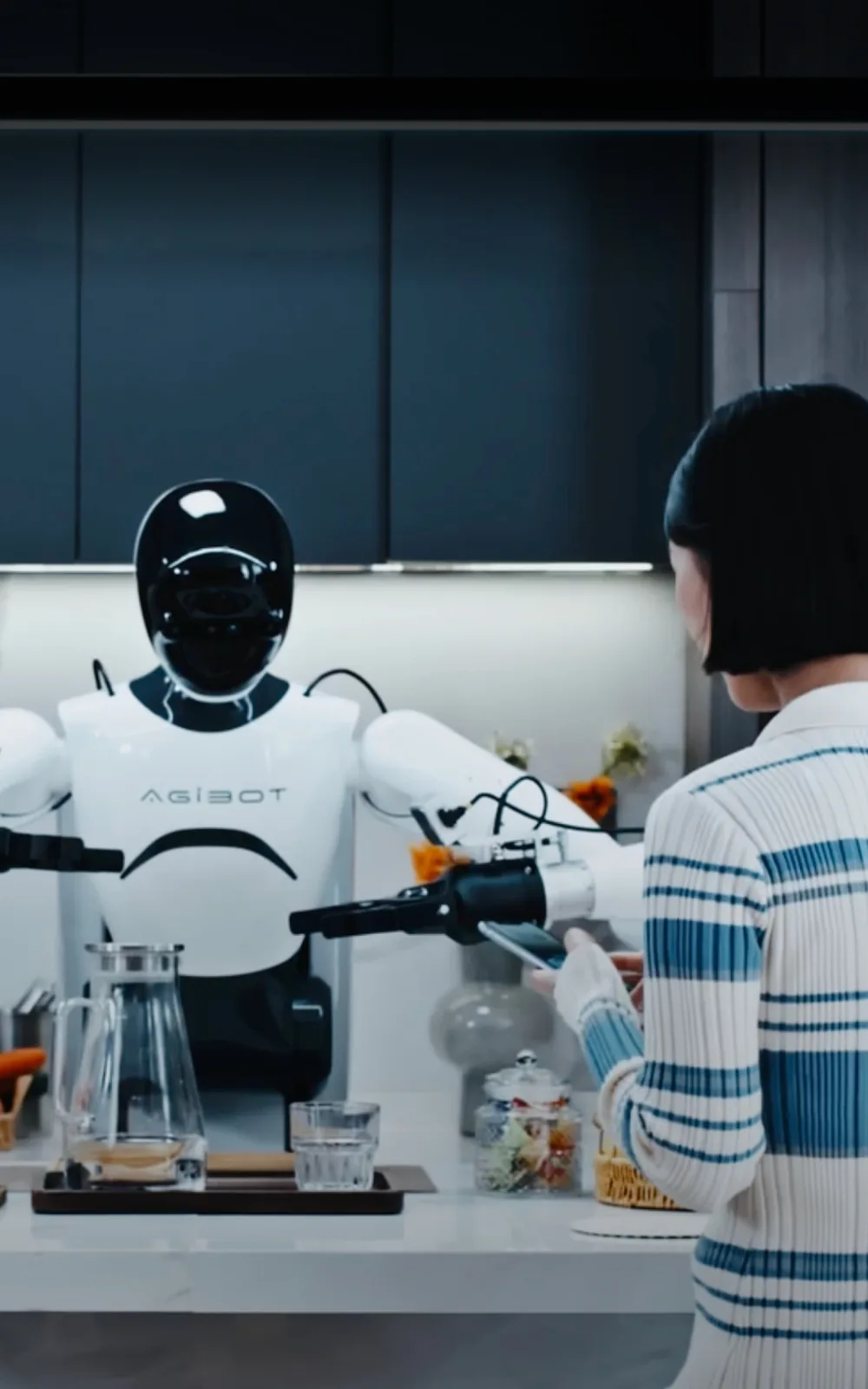 An AGIBOT humanoid robot working in a kitchen with a person