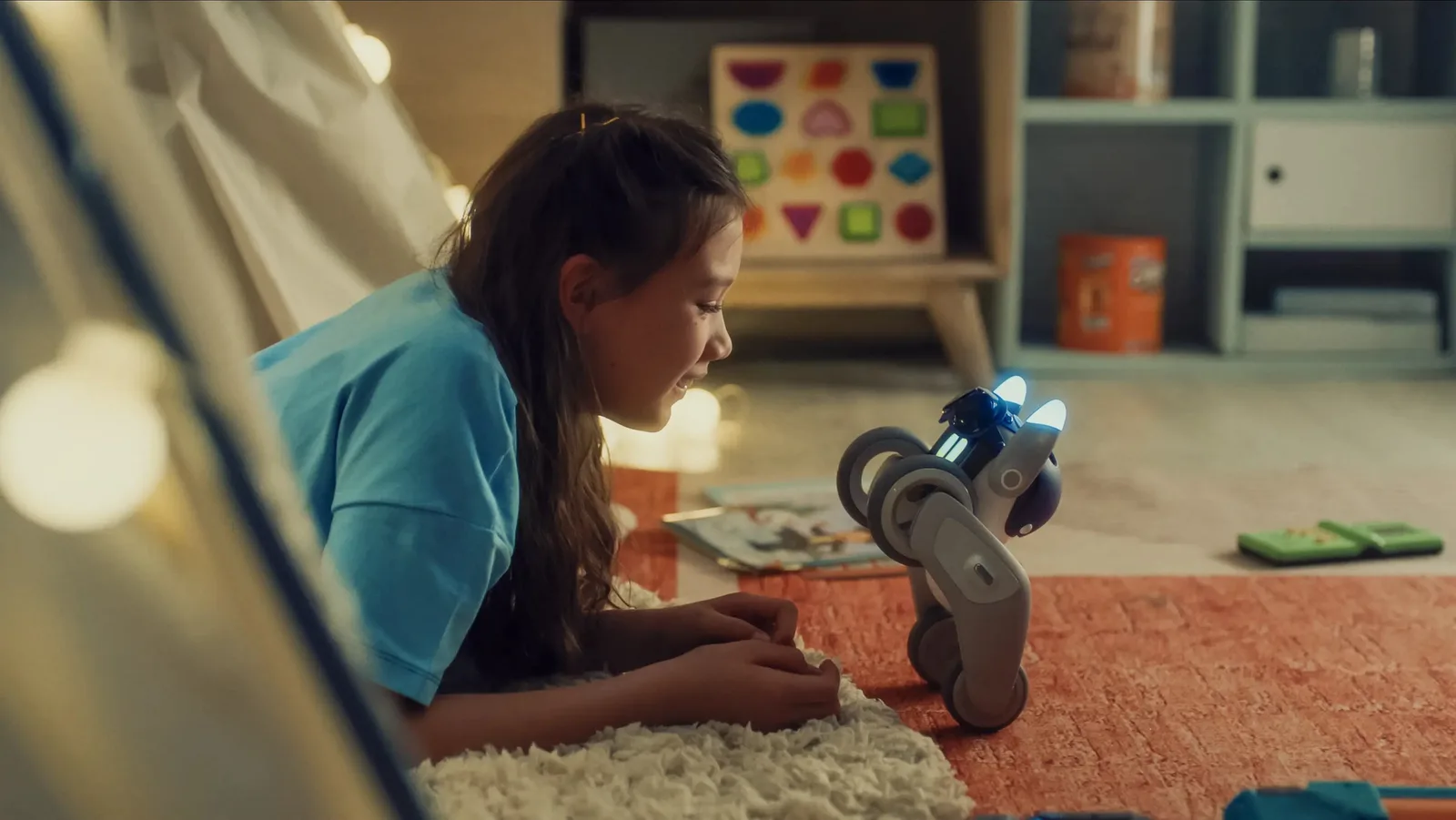 A child playing with the Loona Petbot robot