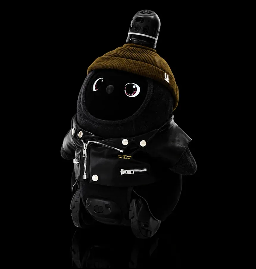 LOVOT companion robot in a black outfit