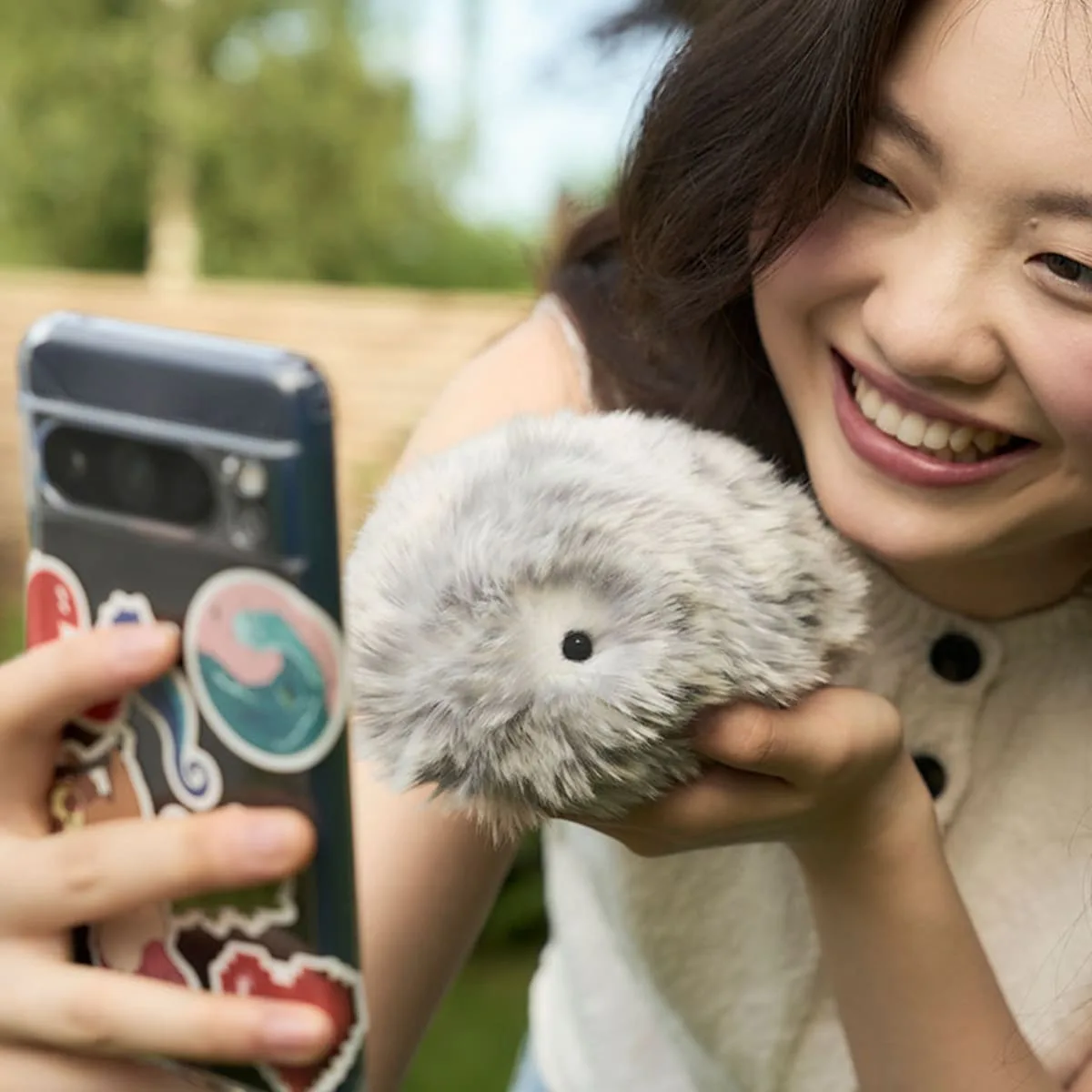 A woman cradling a Casio Moflin